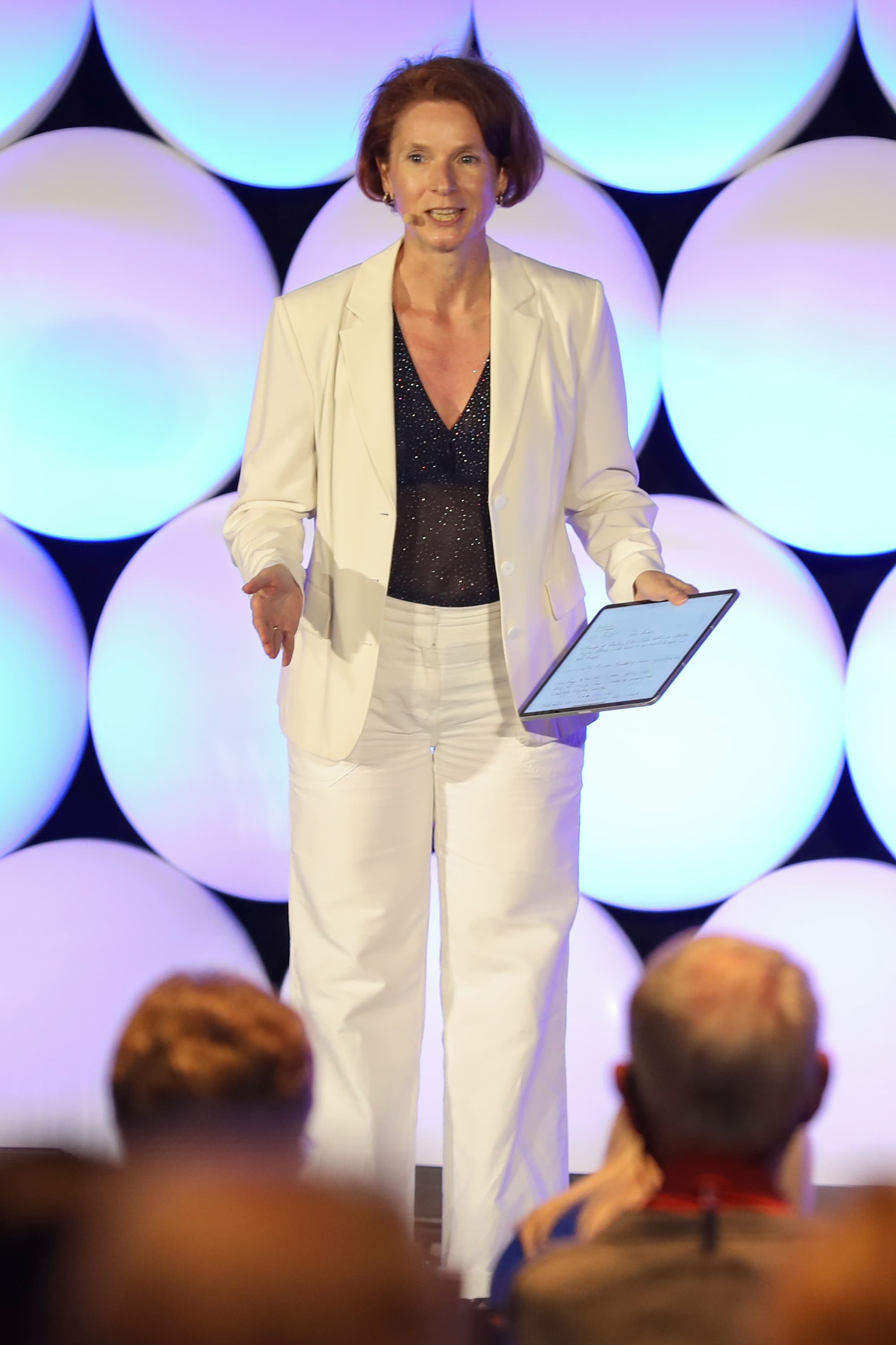 Dr. Ines O'Donovan, PhD, speaking on stage as the creator of Bio-Optimized Leadership™